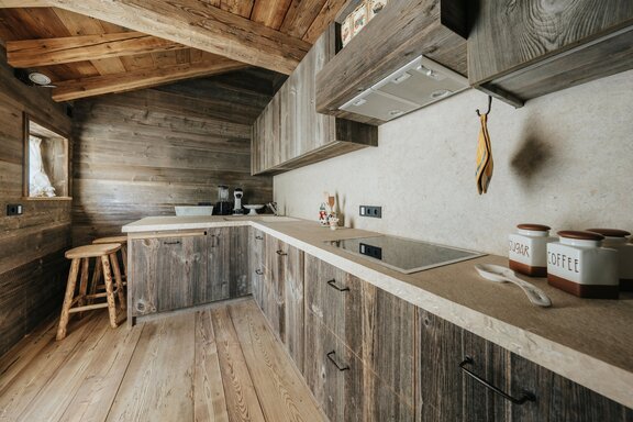 Custom-made kitchen made of reclaimed wood and natural stone