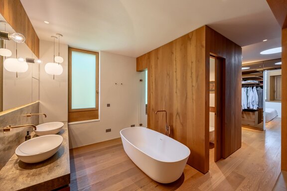 Adjoining master bathroom with a sauna that gets natural light