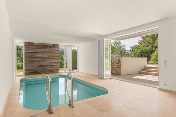 A light-filled indoor pool with direct access to the garden
