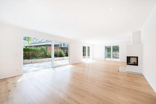 Light filled living area with open fireplace