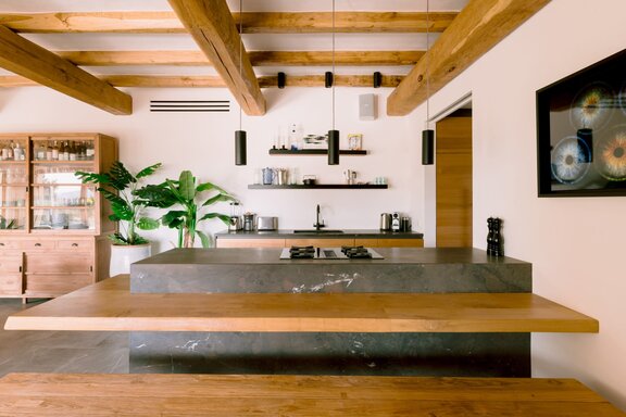 Kitchen with a striking natural stone island and warm wood accents