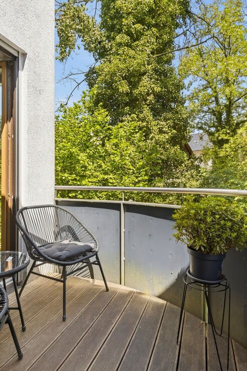 A cozy balcony with a view of the greenery