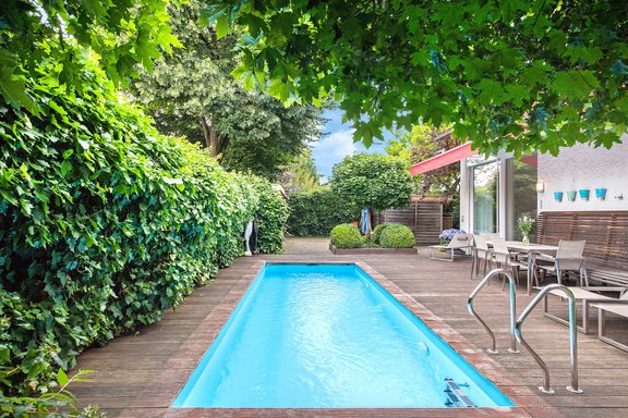 Overgrown garden with heated pool