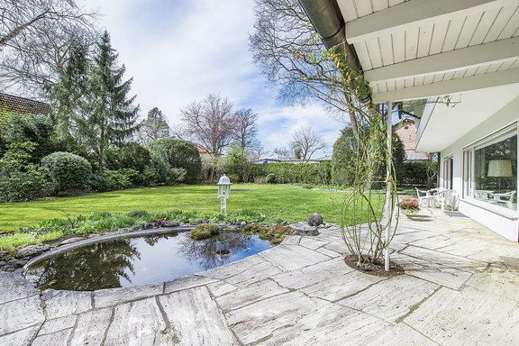 Sonnige Terrasse mit Teich