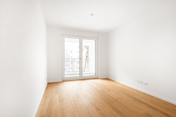 Spacious bedroom with floor to ceiling window