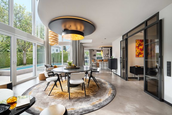 Representative, open-plan living and dining concept with flowing transitions