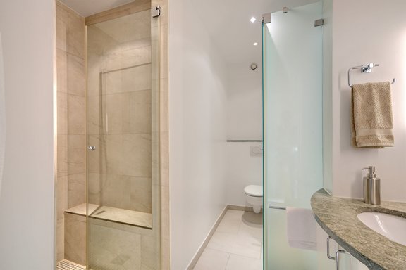 Comfortable shower room with natural stone surfaces