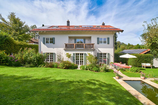 The harmonious, richly detailed family home is nestled in an enchanting garden