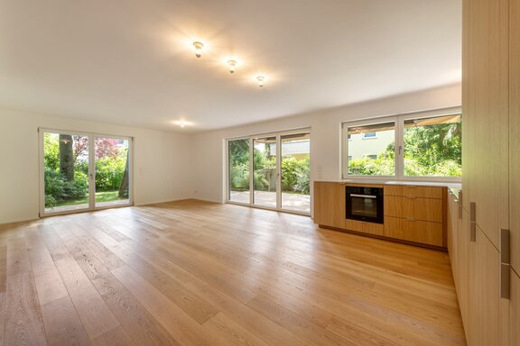 Open-concept living and dining area with access to the patio