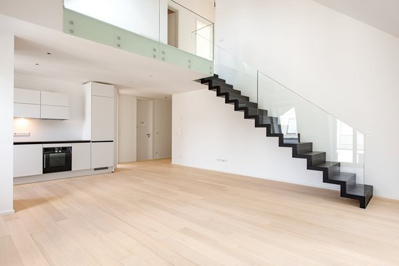 Living room with view to the kitchen and hallway