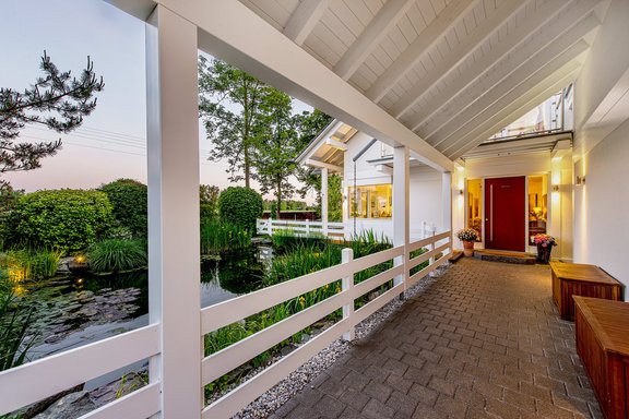 House entrance with swimming pond