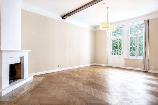 Living room with fireplace and south-facing balcony