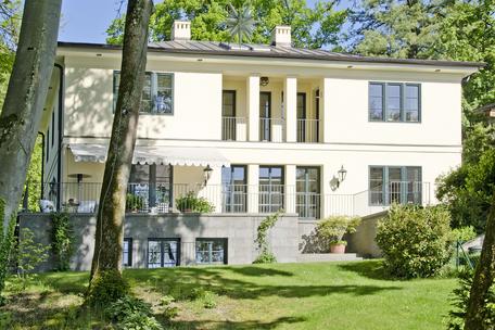Stately lakeside villa with exquisite furnishings and swimming pool on sunny lakefront property