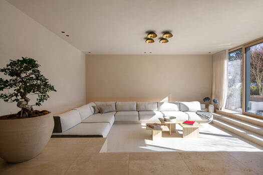 Sunlit living area with built-in upholstered furniture