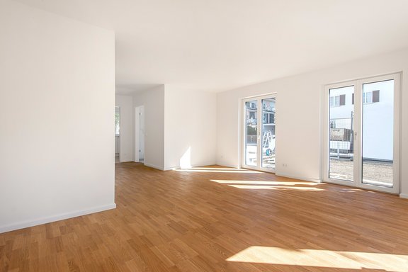Living area with view to the entrance area and kitchen