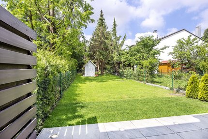 Sunny west garden with illuminated terrace