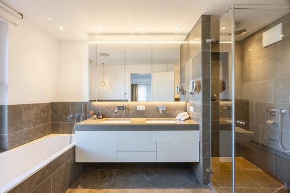 The master bathroom is equipped with a walk-in shower and a bathtub