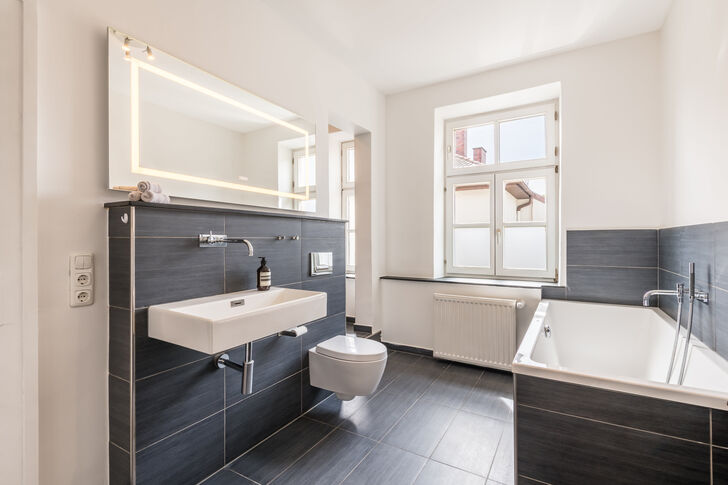Bathroom with a tub and shower