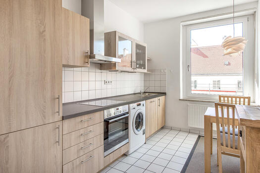 Modern fitted kitchen with light fronts