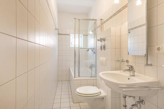 Daylight bathroom, brightly tiled with tub