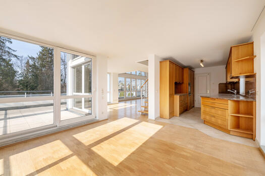 Open-concept living and dining area with an adjacent bulthaup built-in kitchen