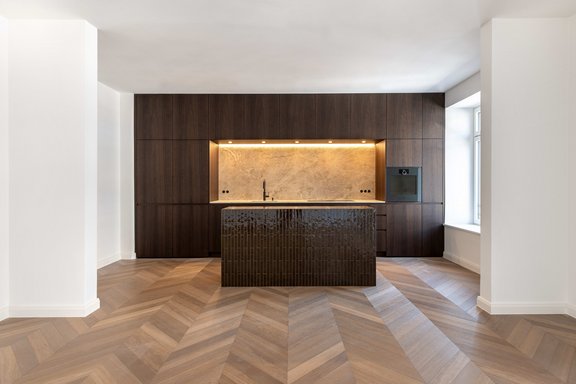 Custom-built kitchen with a natural stone countertop