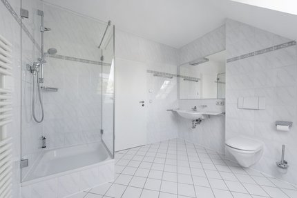 Bright bathroom with shower cubicle and large dormer windows