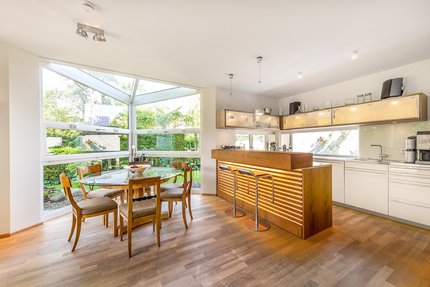 Dining area in a wonderfully transparent glass bay window