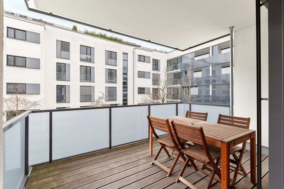 Spacious balcony with a quiet west-facing view of the courtyard