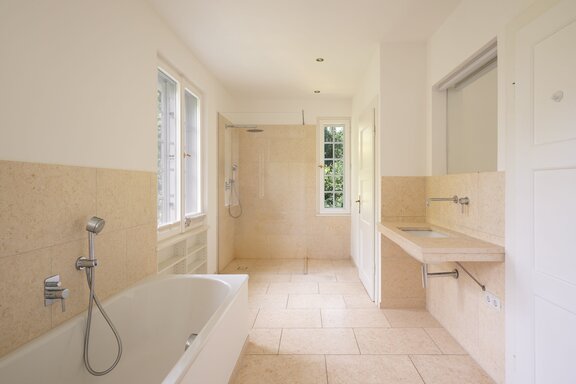 Natural stone bathrooms bathed in light throughout the house