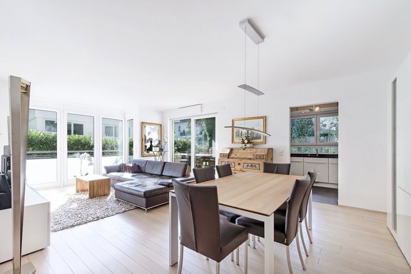 Living and dining area with floor-to-ceiling glass fronts