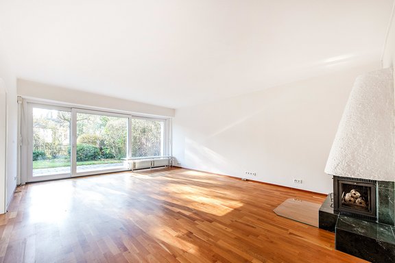 Spacious living area with fireplace and terrace access