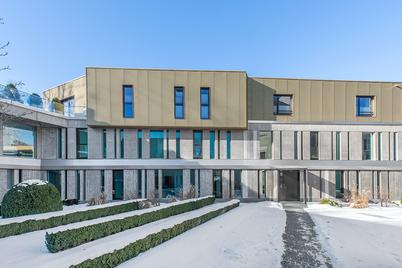 Sunny garden apartment with exclusive equipment in futuristic architectural monument at the castle park