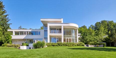 Spectacular villa estate on Lake Starnberg with a stunning lake view, a boathouse, and a private dock