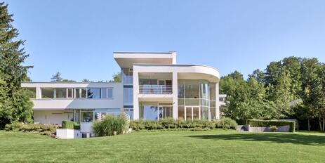 Spectacular villa estate on Lake Starnberg with a stunning lake view, a boathouse, and a private dock