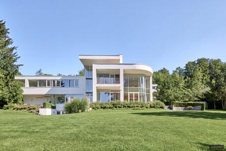 Spectacular villa estate on Lake Starnberg with a stunning lake view, a boathouse, and a private dock