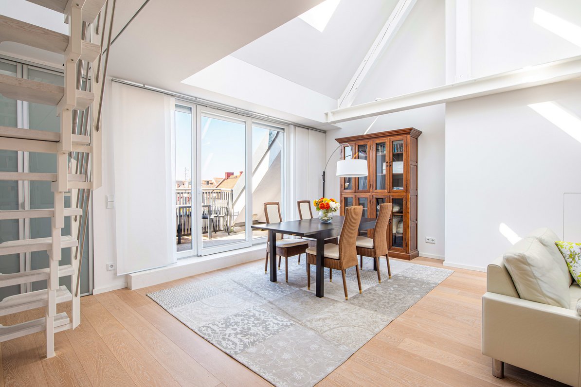 Living/dining area with access to the west-facing balcony