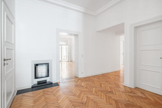 Modern fireplace in the hallway and tiled stove in the kitchen-living room