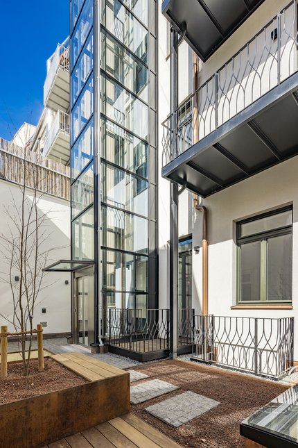 Modern glass lift in the inner courtyard