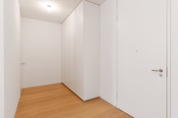 Hallway with practical storage areas