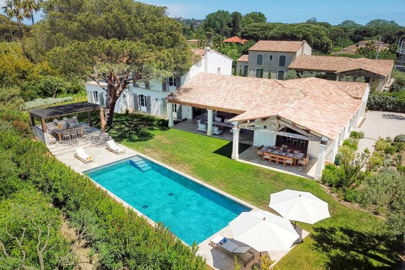 View of the property with a pool and outdoor living area