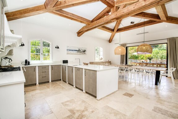 Designer kitchen with elegant finishes and an exposed roof truss