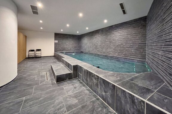 Indoor Pool Featuring Timeless Natural Stone Architecture