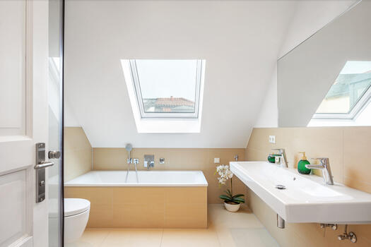 Light filled main bathroom with bathtub and shower