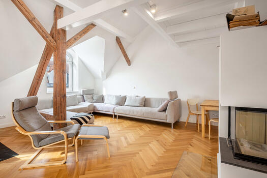 The modern heating fireplace provides a cozy ambience in the spacious living / dining area